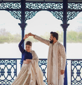 Bride and groom posing near gazebo during outdoor pre wedding shoot