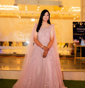 Bride posing in shimmering peach gown at reception venue