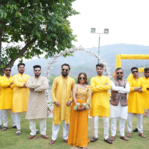 Bridesmaids posing in coordinated yellow outfits during mehndi or haldi ceremony