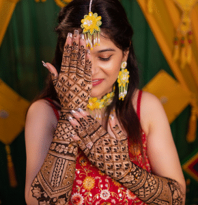 Bride showing intricate mehndi during pre wedding celebration