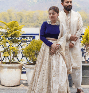 Bride and groom posing on balcony with scenic background