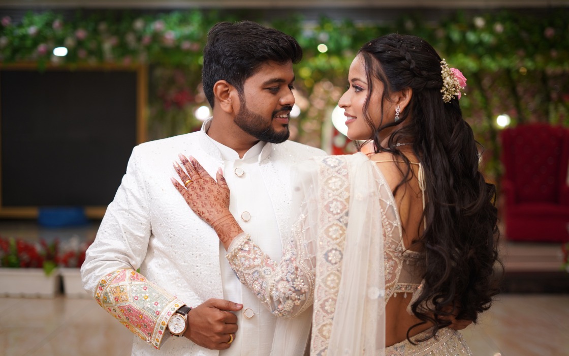 Wedding couple posing in elegant attire in natural outdoor setting