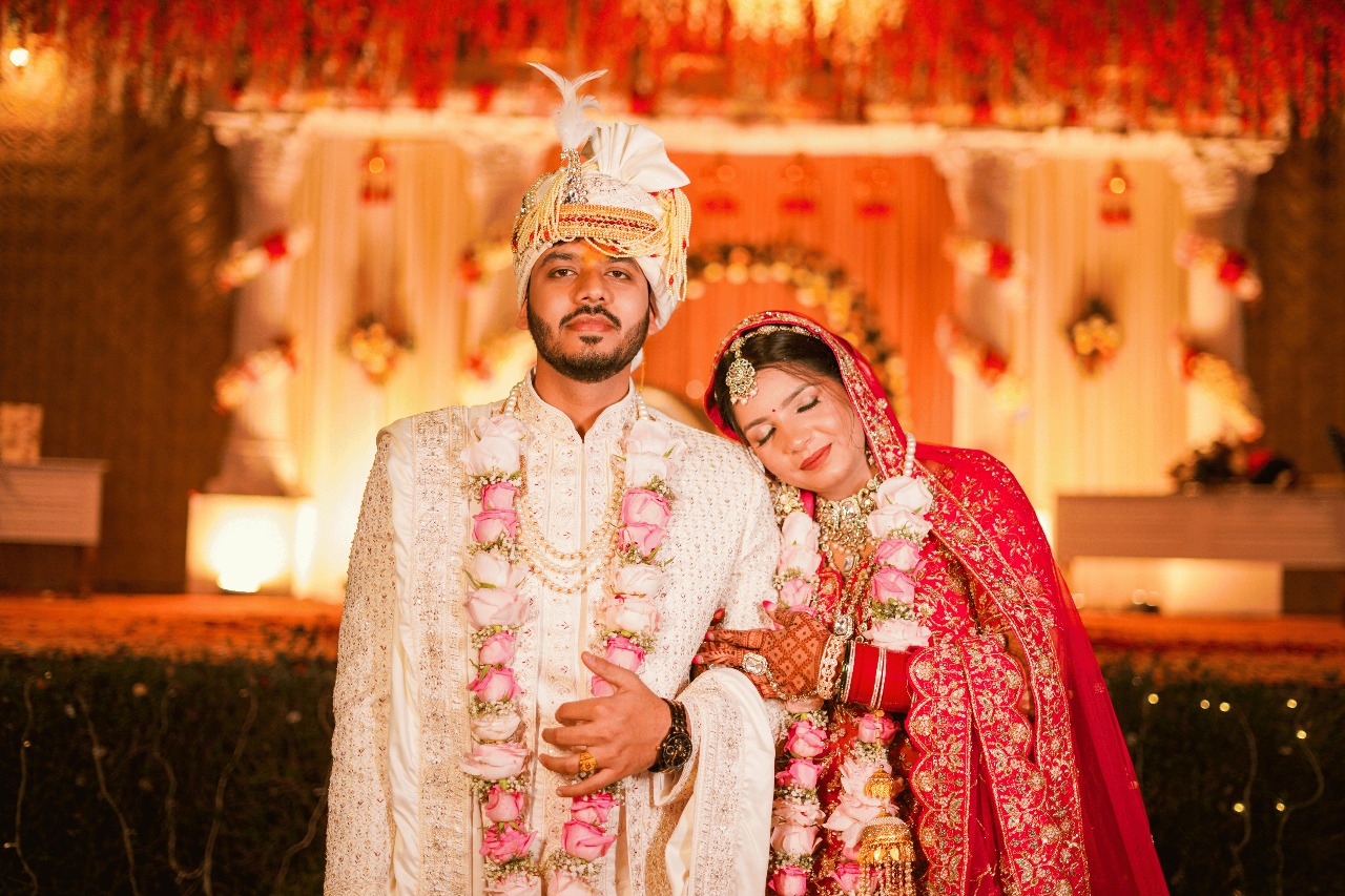 Bride and groom posing in cultural wedding attire during ceremony