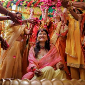 Bride and family celebrating colorful mehndi ceremony with dance