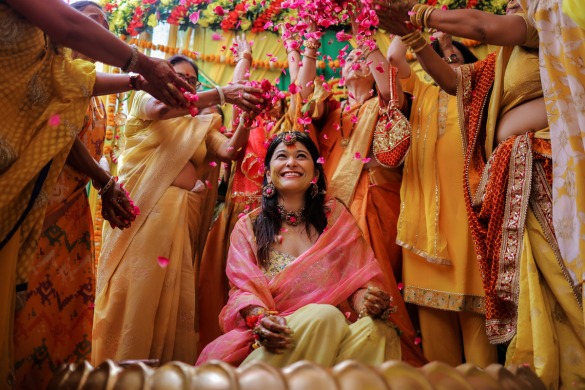 Bride and family celebrating colorful mehndi ceremony with dance